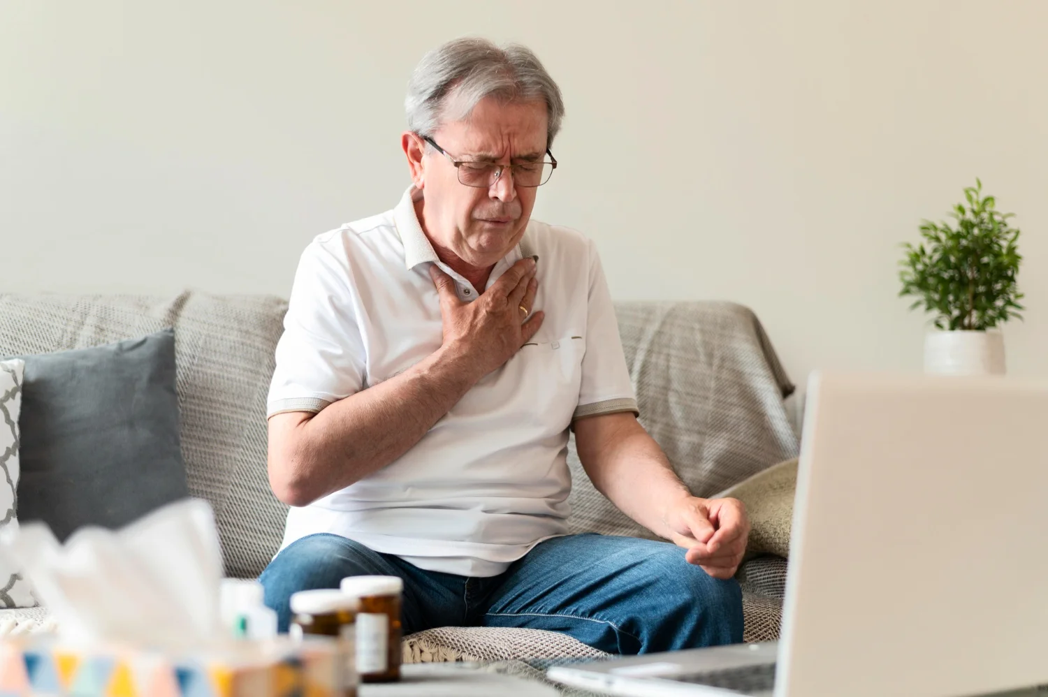 Person experiencing chest pain and heart-related symptoms, showing signs of cardiac discomfort
