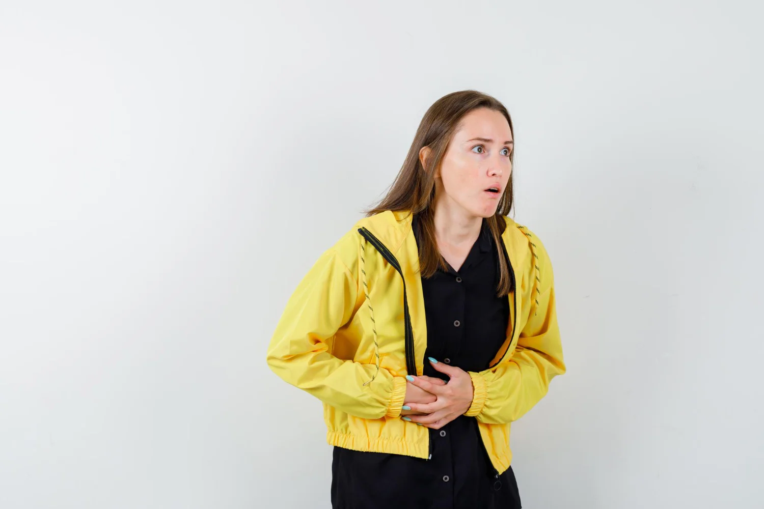Person experiencing digestive discomfort and stomach issues, showing common symptoms of indigestion