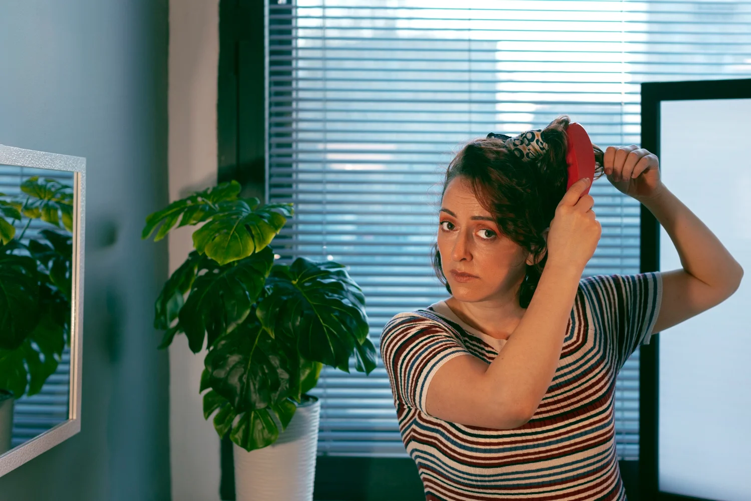 Woman experiencing hormonal imbalance symptoms including mood changes and hair loss