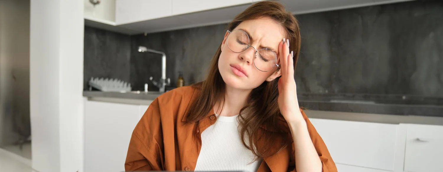 Person experiencing severe headache or migraine pain, showing common symptoms of head pain